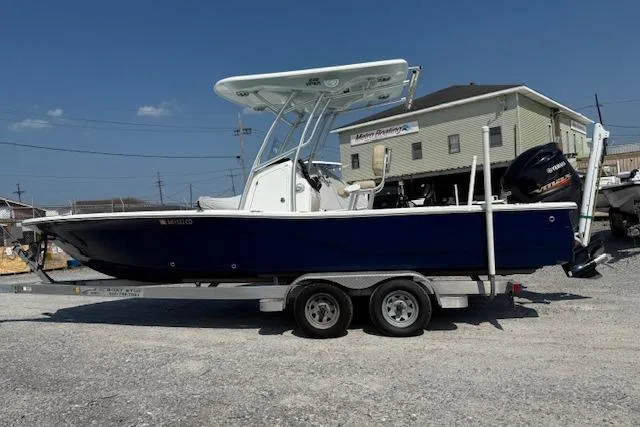 The Image of 2016 Sea Fox 240 Viper boat on trailer, parked outdoors under clear sky. - 1