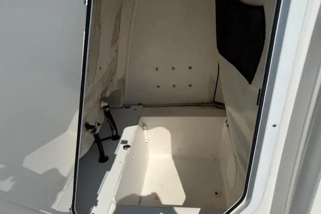 Slide: The Image of 2016 Sea Fox 240 Viper boat interior compartment, featuring clean white surfaces and storage space. - 9