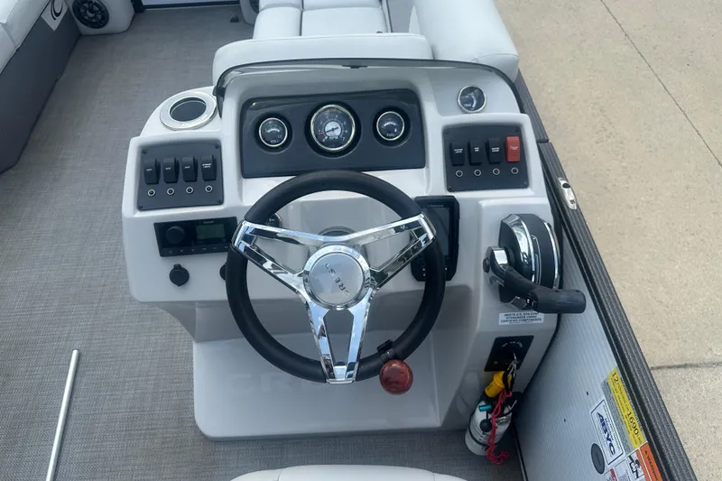 Slide: The Image of 2022 Crest Classic LX 200 boat dashboard with steering wheel and control panel. - 10