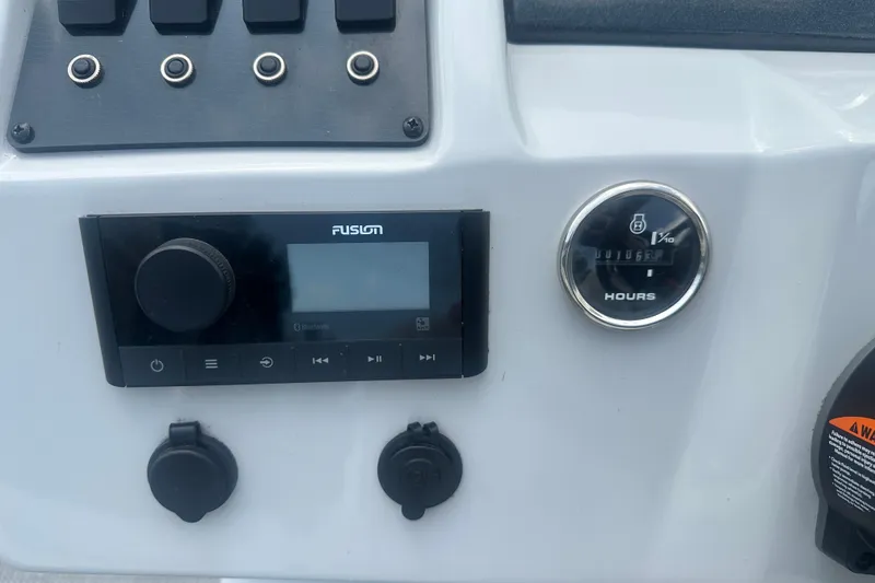 Slide: The Image of Control panel of 2022 Crest Classic LX 200 with audio system and hour meter. - 12