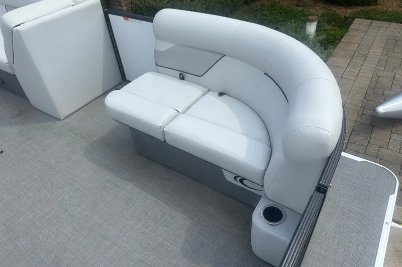 Slide: The Image of 2022 Crest Classic LX 200 boat with white cushioned seating and cup holder. - 4