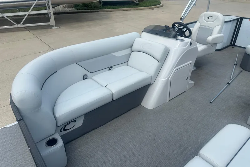 Slide: The Image of 2022 Crest Classic LX 200 pontoon boat interior with plush seating and steering console. - 5