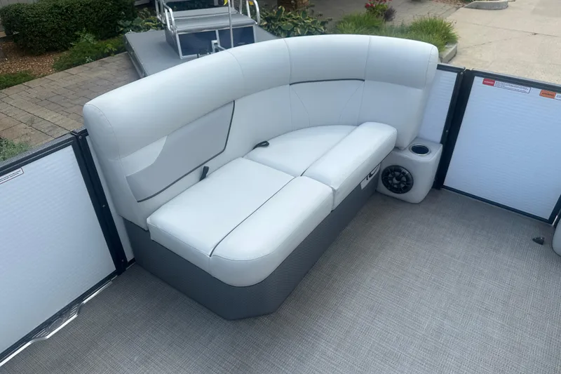 Slide: The Image of 2022 Crest Classic LX 200 boat interior with white cushioned seating and speaker. - 6