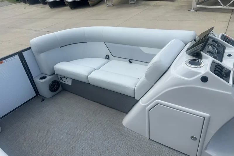 Slide: The Image of 2022 Crest Classic LX 200 boat interior with white seating and control panel. - 7