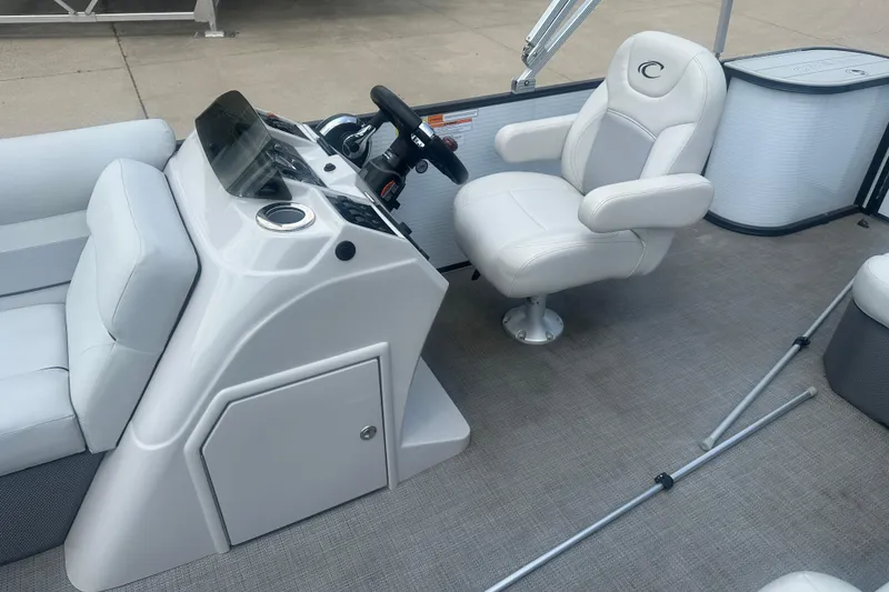 Slide: The Image of 2022 Crest Classic LX 200 boat interior with helm, steering wheel, and white captain's chair. - 8
