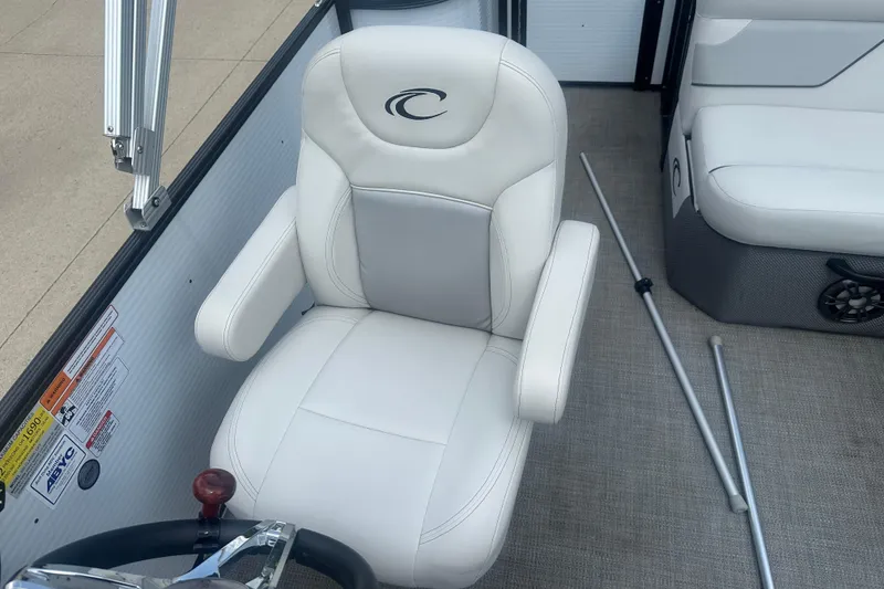 Slide: The Image of Captain's chair in 2022 Crest Classic LX 200 boat, featuring white upholstery and armrests. - 9