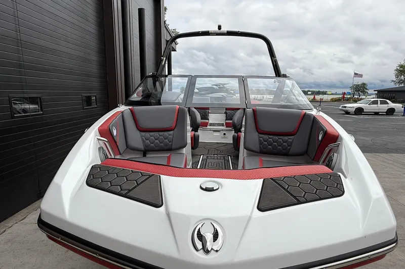 Slide: The Image of 2026 Scarab 195 LX boat with sleek design, red and gray seating, docked outdoors. - 10