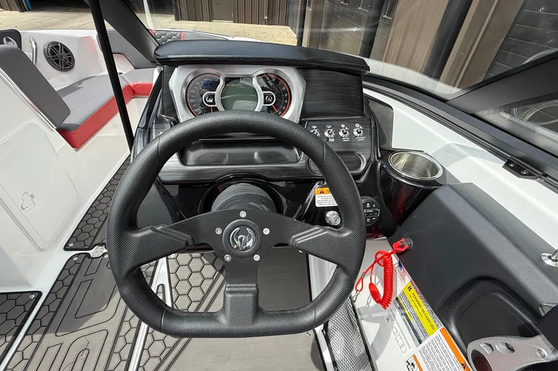 Slide: The Image of 2026 Scarab 195 LX boat dashboard with steering wheel and control panel. - 11