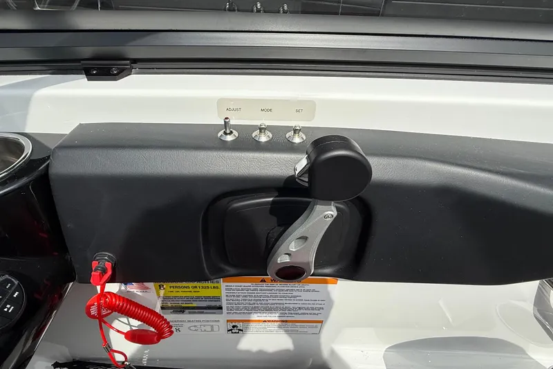 Slide: The Image of Control panel of 2026 Scarab 195 LX boat with switches and throttle lever. - 13