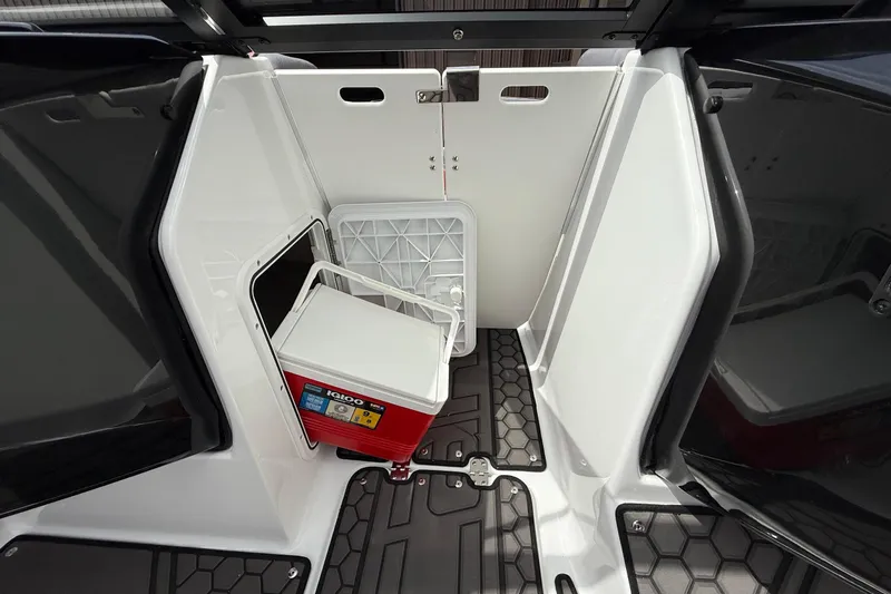 Slide: The Image of 2026 Scarab 195 LX boat interior with storage compartment and cooler. - 19