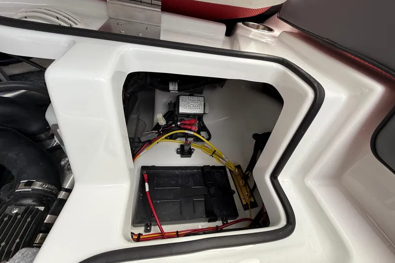 Slide: The Image of Engine compartment of 2026 Scarab 195 LX boat, showing wiring and battery setup. - 22