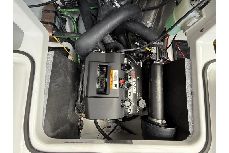 Slide: The Image of Engine compartment of 2026 Scarab 195 LX boat featuring Rotax engine components. - 23