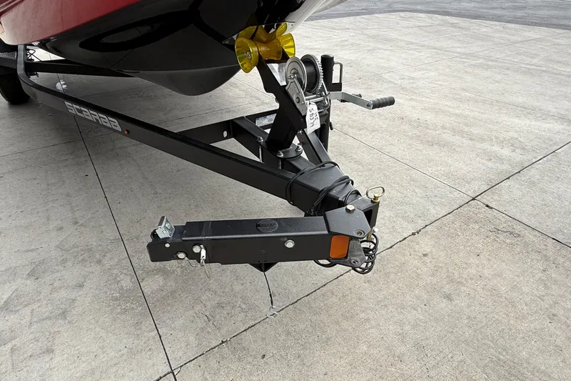 Slide: The Image of Trailer hitch of a 2026 Scarab 195 LX boat on concrete surface. - 30