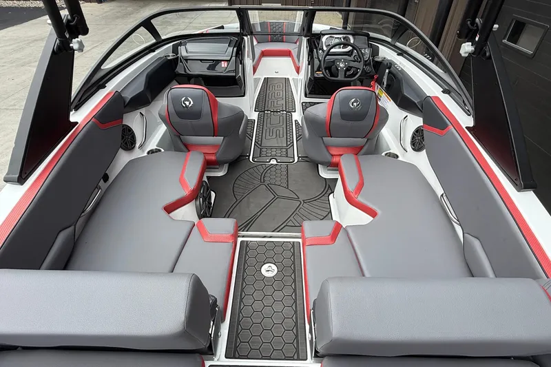 Slide: The Image of 2026 Scarab 195 LX boat interior with gray and red seating, modern dashboard, and spacious layout. - 9