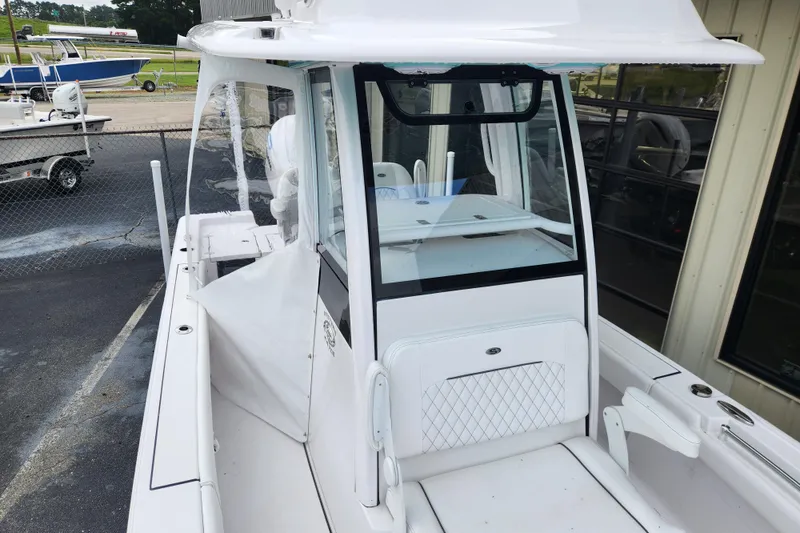 Slide: The Image of 2025 Sportsman Masters 247OE Bay Boat, white interior, docked at marina. - 24
