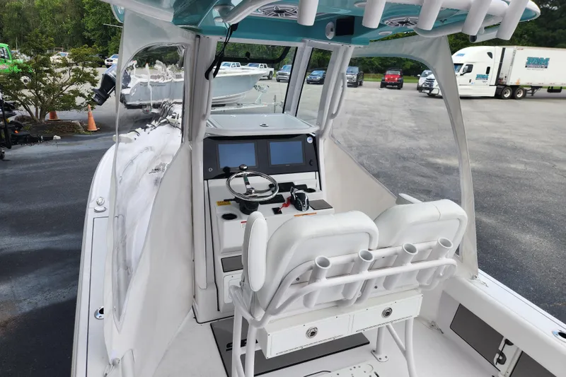 Slide: The Image of 2025 Sportsman Masters 247OE Bay Boat interior with dual seats and modern dashboard. - 26