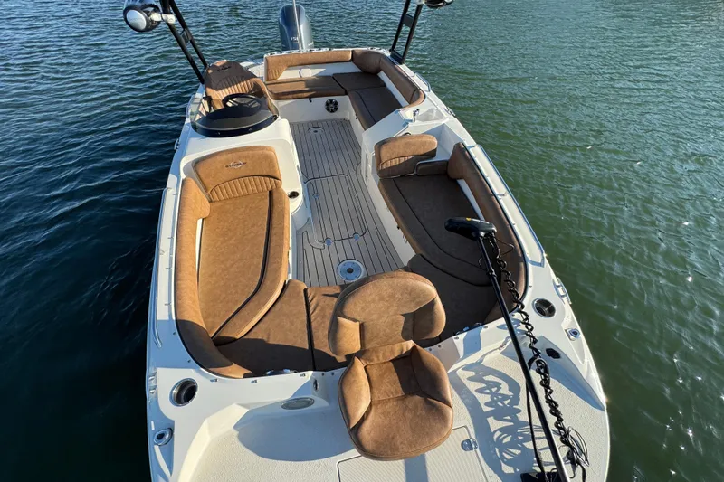 Slide: The Image of 2021 Stingray 192 SC boat with brown seating, on calm water. - 11