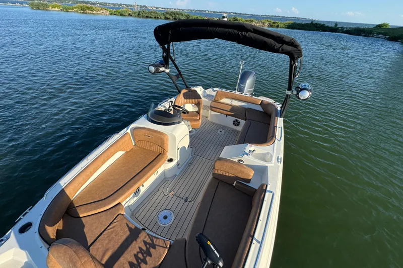 Slide: The Image of 2021 Stingray 192 SC boat with brown seating, on calm water. - 15
