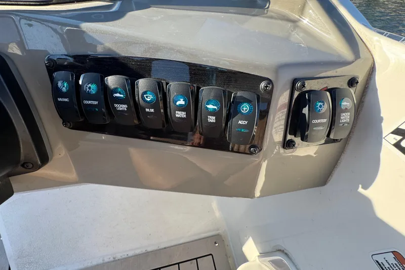 Slide: The Image of Control panel of a 2021 Stingray 192 SC boat with labeled switches. - 18