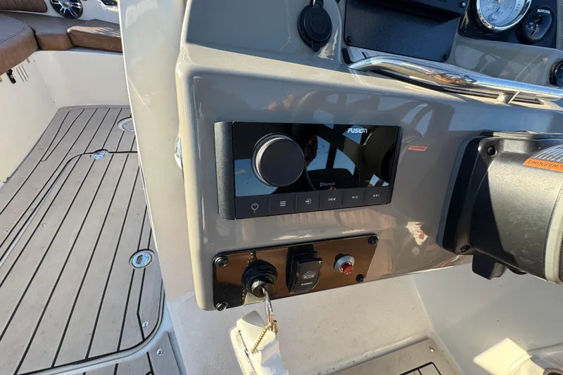 Slide: The Image of 2021 Stingray 192 SC boat dashboard with Fusion audio system and controls. - 19