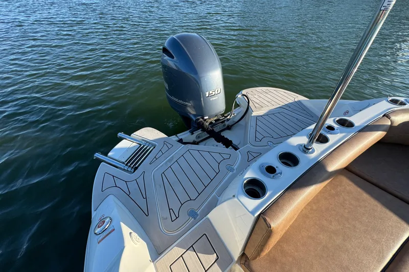 Slide: The Image of 2021 Stingray 192 SC boat with outboard motor on calm water. - 22