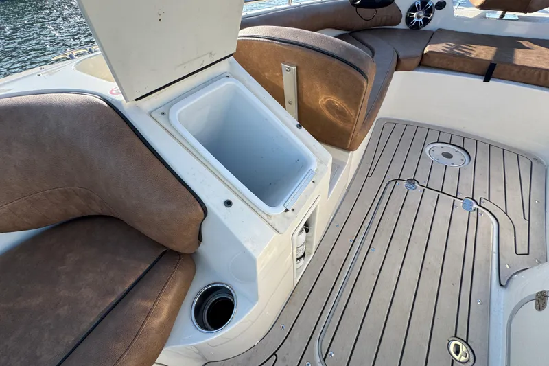 Slide: The Image of 2021 Stingray 192 SC boat interior with open storage compartment and cushioned seating. - 23