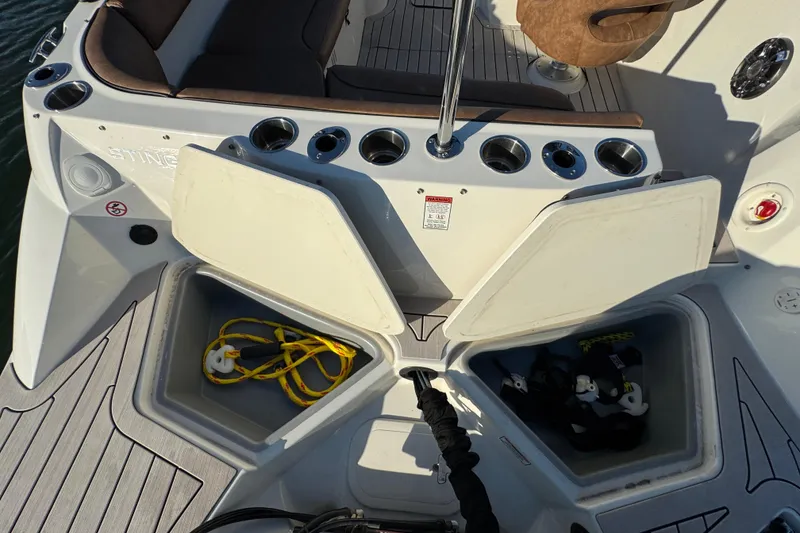 Slide: The Image of 2021 Stingray 192 SC boat interior with open storage compartments and seating area. - 29