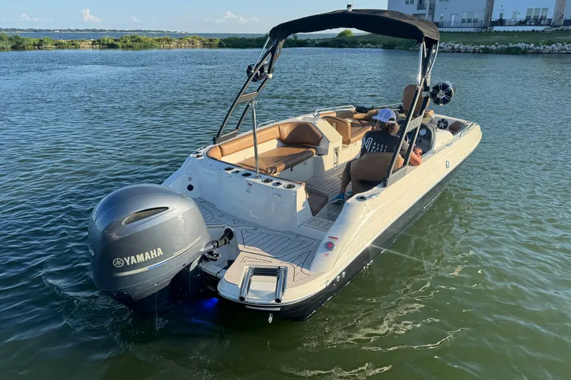 Slide: The Image of 2021 Stingray 192 SC boat with Yamaha engine on a calm lake. - 4