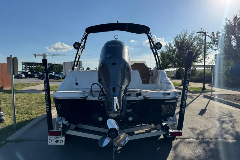 Slide: The Image of 2021 Stingray 192 SC boat on trailer, rear view with outboard motor. - 9