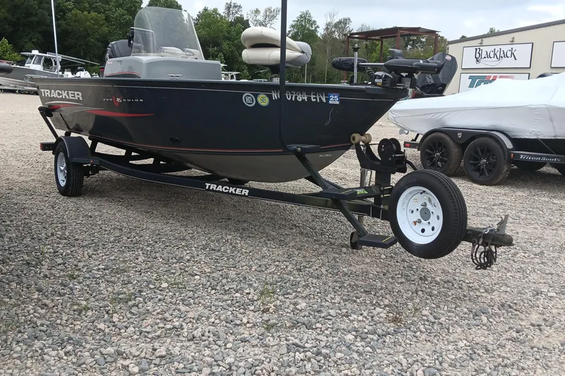 Slide: The Image of 2019 Tracker Pro Guide V-16 SC boat on trailer in outdoor setting. - 2
