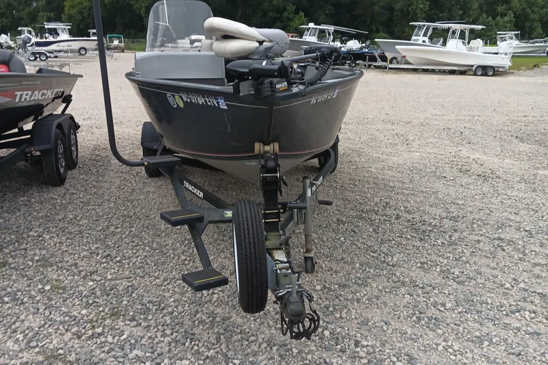 Slide: The Image of 2019 Tracker Pro Guide V-16 SC boat on a trailer in a gravel lot. - 4
