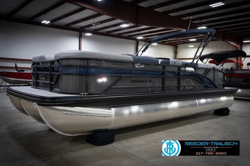 The Image of 2026 Bennington 23 SLJ pontoon boat in showroom, featuring sleek design and modern amenities. - 2