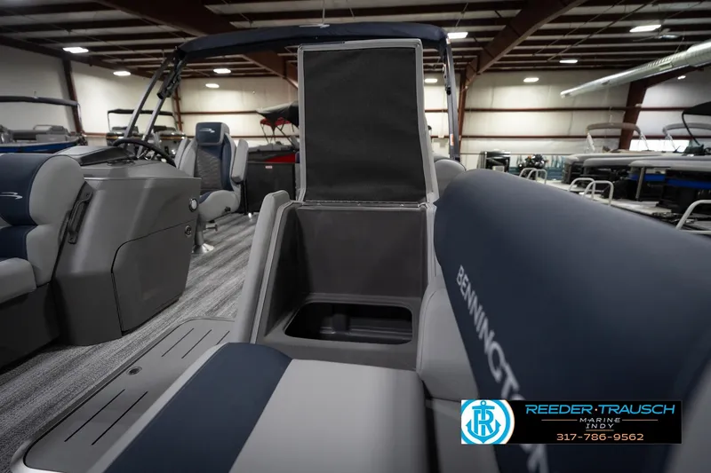 Slide: The Image of 2026 Bennington 23 SLJ boat interior with gray and blue seating in showroom. - 23