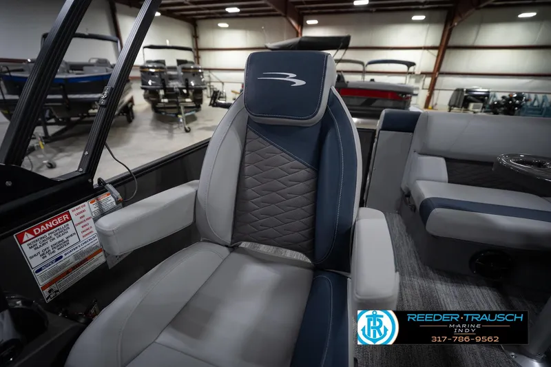 Slide: The Image of 2026 Bennington 23 SLJ boat interior with luxury seating in showroom. - 25