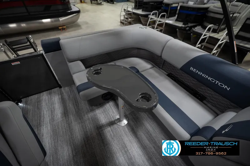 Slide: The Image of 2026 Bennington 23 SLJ boat interior with luxurious seating in showroom. - 26