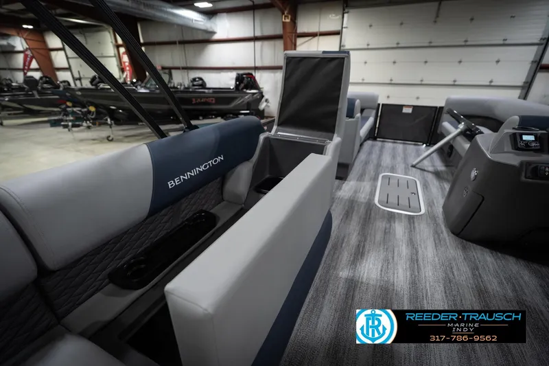 Slide: The Image of Interior of 2026 Bennington 23 SLJ boat with blue and gray seating in showroom. - 31