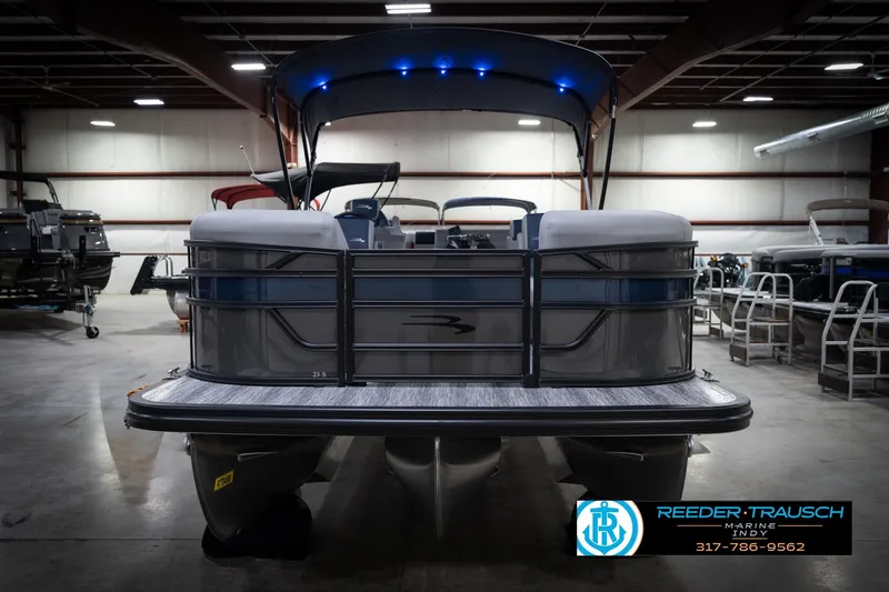 Slide: The Image of 2026 Bennington 23 SLJ pontoon boat in showroom with canopy and sleek design. - 4