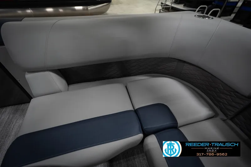 Slide: The Image of 2026 Bennington 23 SLJ boat interior with gray and blue seating, featuring logo embroidery. - 44
