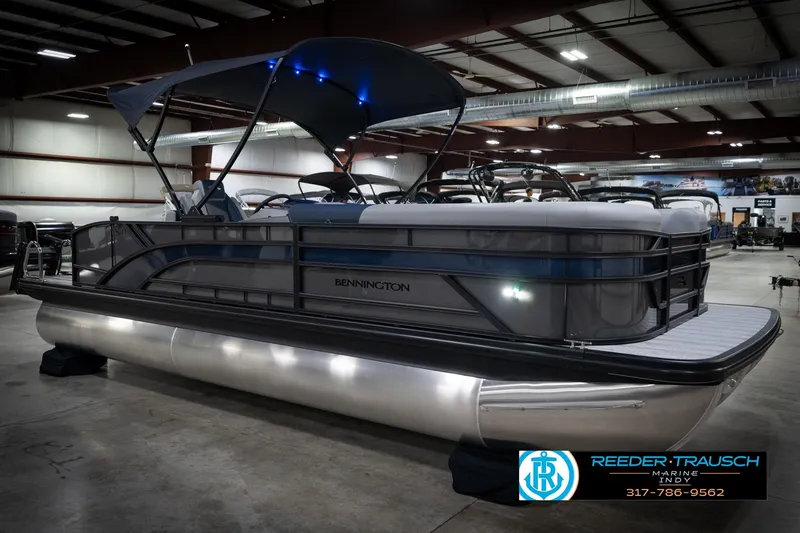 Slide: The Image of 2026 Bennington 23 SLJ pontoon boat in showroom, featuring sleek design and modern amenities. - 5
