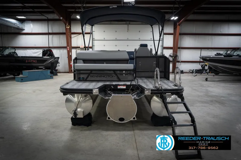 Slide: The Image of 2026 Bennington 23 SLJ pontoon boat in showroom with canopy and seating. - 8