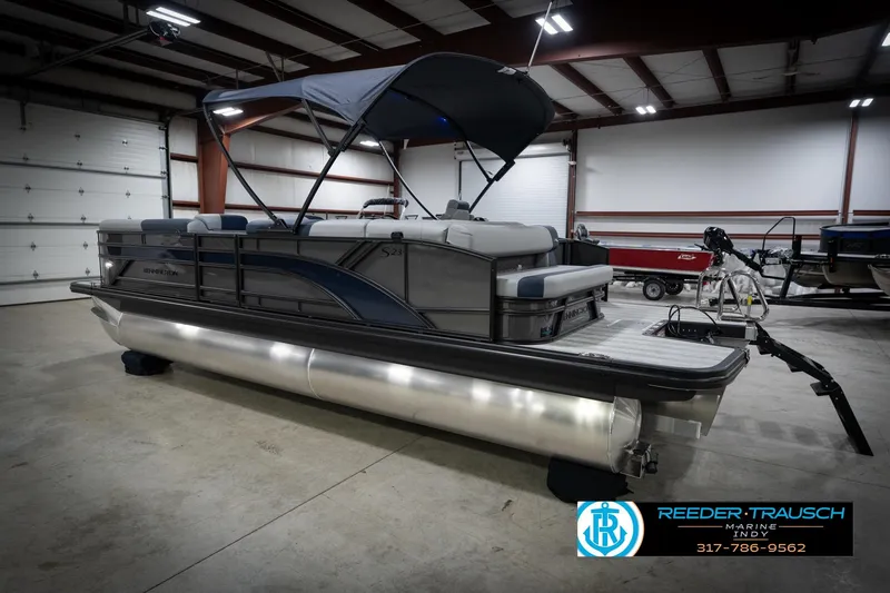Slide: The Image of 2026 Bennington 23 SLJ pontoon boat in showroom, rear view with canopy. - 9