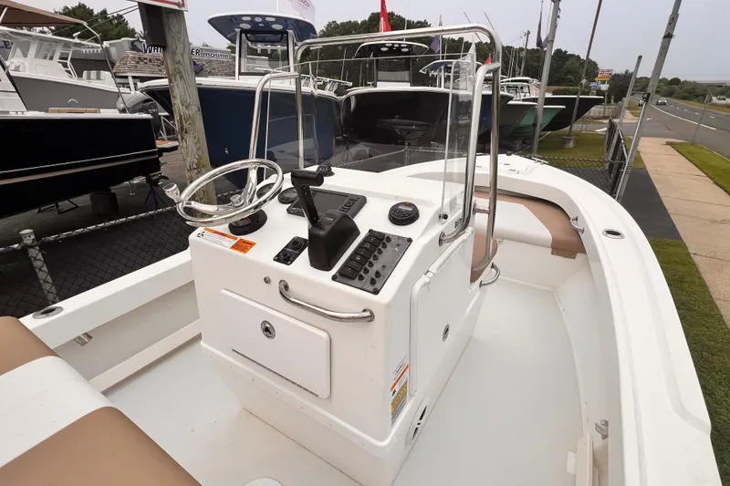 Slide: The Image of 2017 Parker 1801 Center Console boat with steering wheel and control panel. - 2