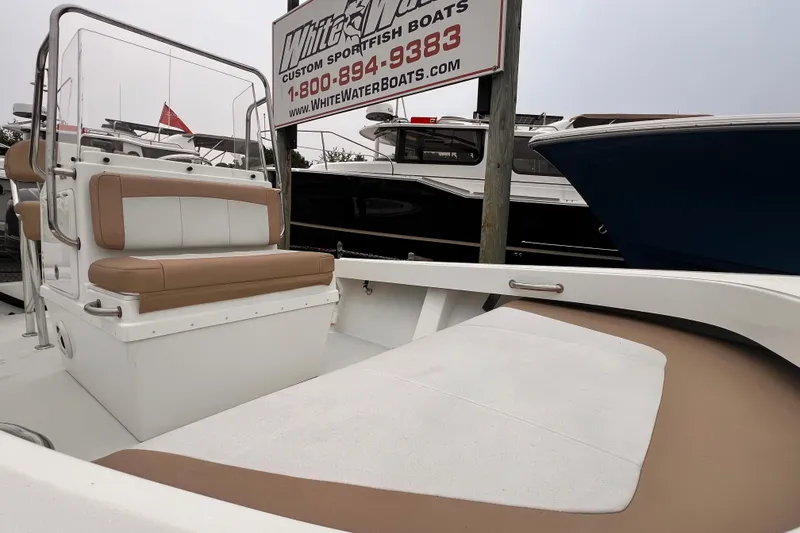 Slide: The Image of 2017 Parker 1801 Center Console boat with tan seating, docked near other vessels. - 5