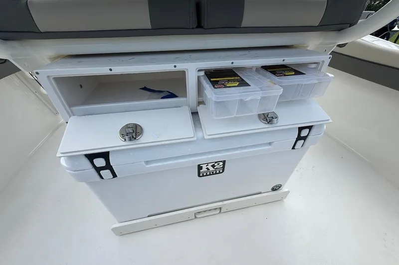 Slide: The Image of 2026 Key West 219 FS boat storage area with cooler and tackle boxes. - 10