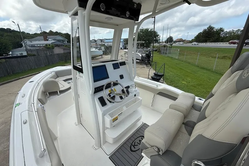 Slide: The Image of 2026 Key West 219 FS boat interior with modern helm and seating. - 11