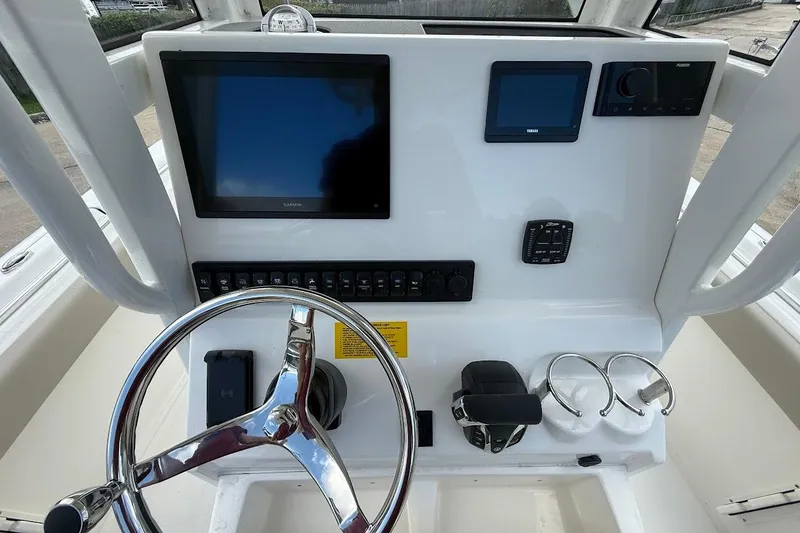 Slide: The Image of 2026 Key West 219 FS boat dashboard with steering wheel and electronic displays. - 14
