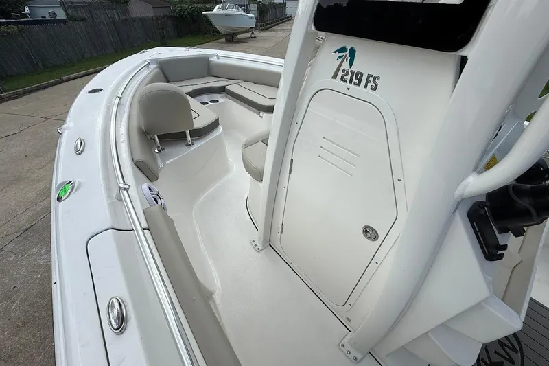 Slide: The Image of 2026 Key West 219 FS boat interior with seating and storage compartments. - 16