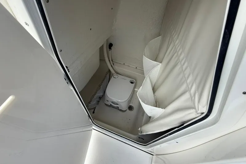 Slide: The Image of 2026 Key West 219 FS boat interior with compact marine toilet. - 17