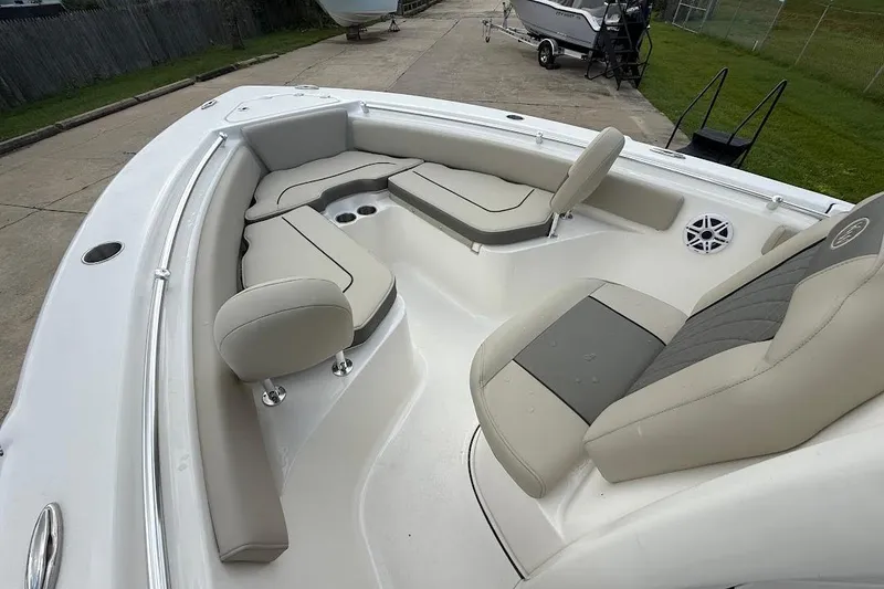 Slide: The Image of 2026 Key West 219 FS boat interior with beige seating and cup holders. - 18