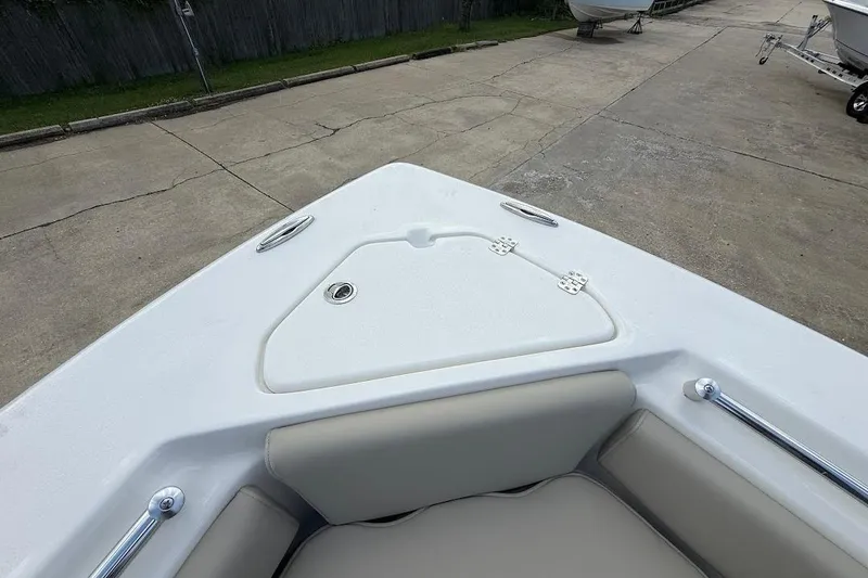 Slide: The Image of Bow seating area of 2026 Key West 219 FS boat, featuring storage compartment. - 23